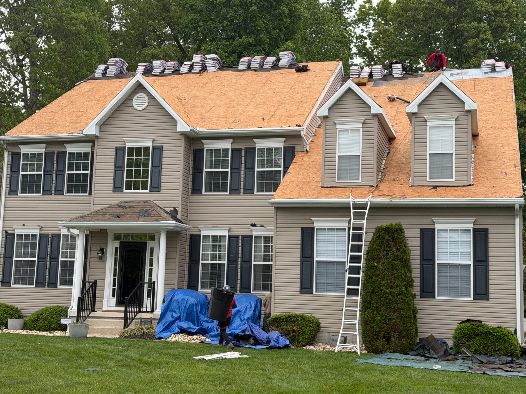 Roof deck prepped with shingle bundles staged for installation